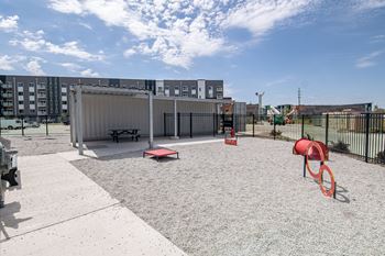 A playground with a slide, swings, and a picnic table.